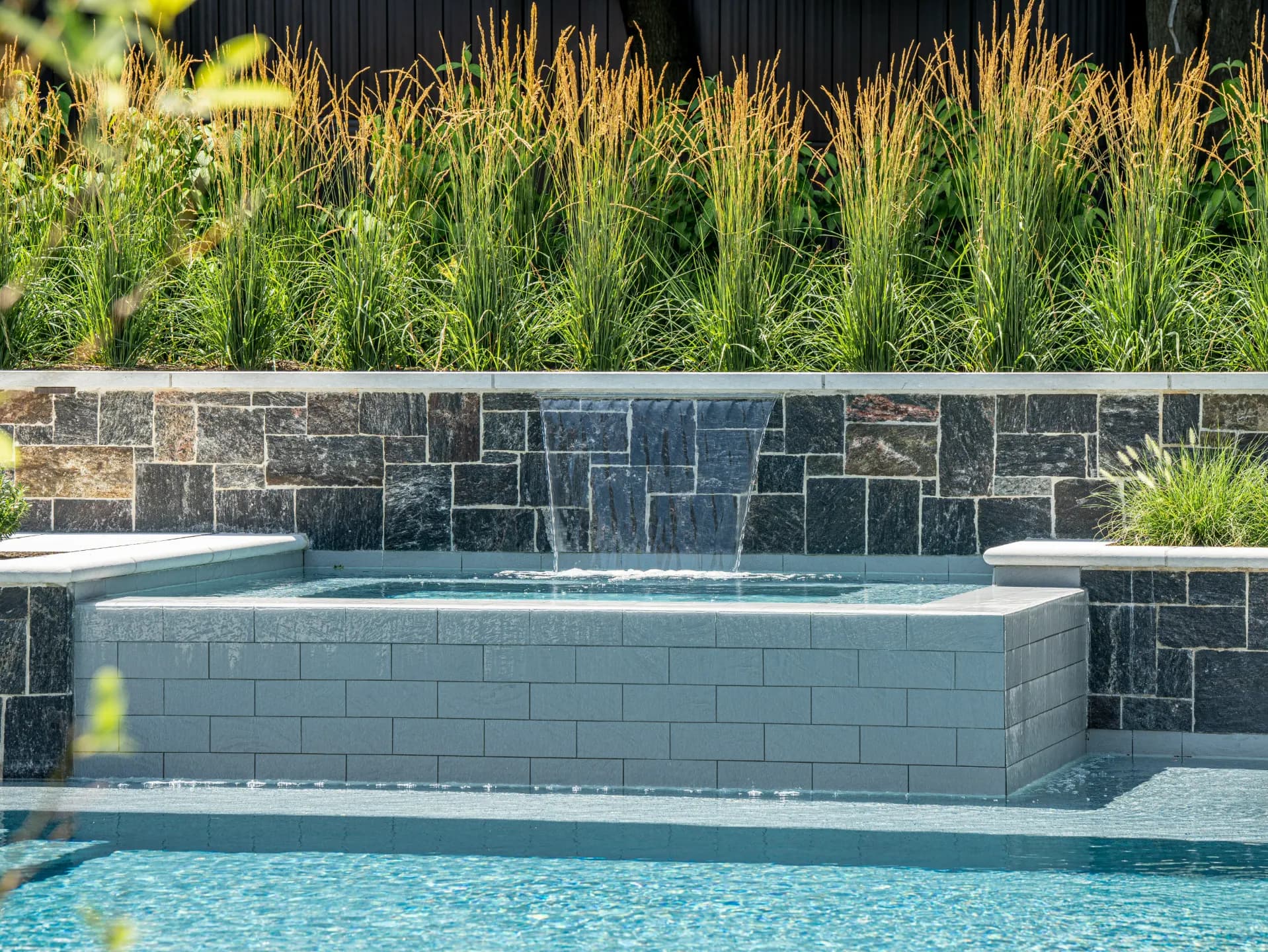 Dramatic dusk shot of a completed Redwood luxury outdoor project with landscape lighting